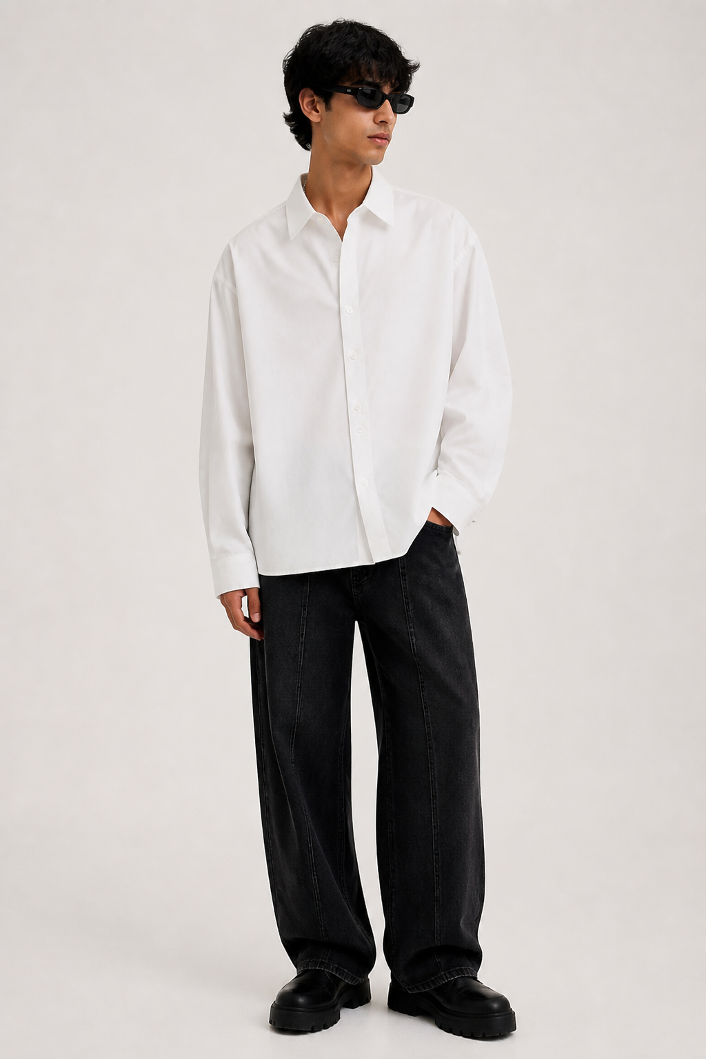 A white oversized shirt with enough structure to avoid looking borrowed.
